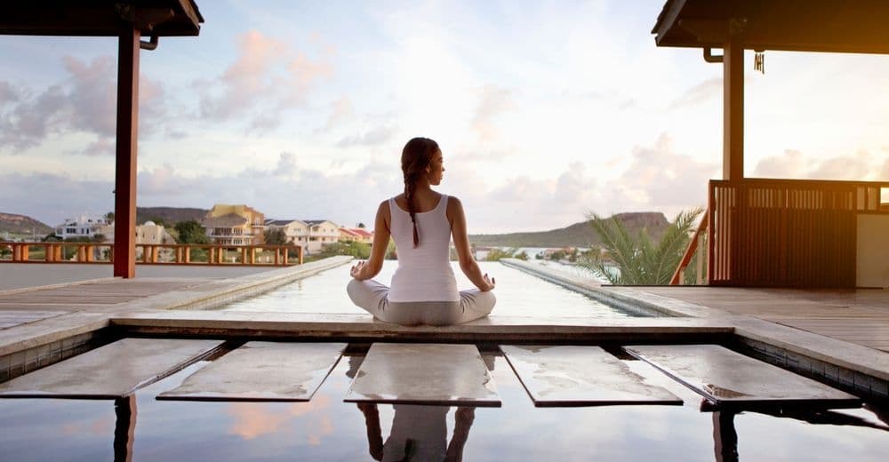 Woman meditating at sunset