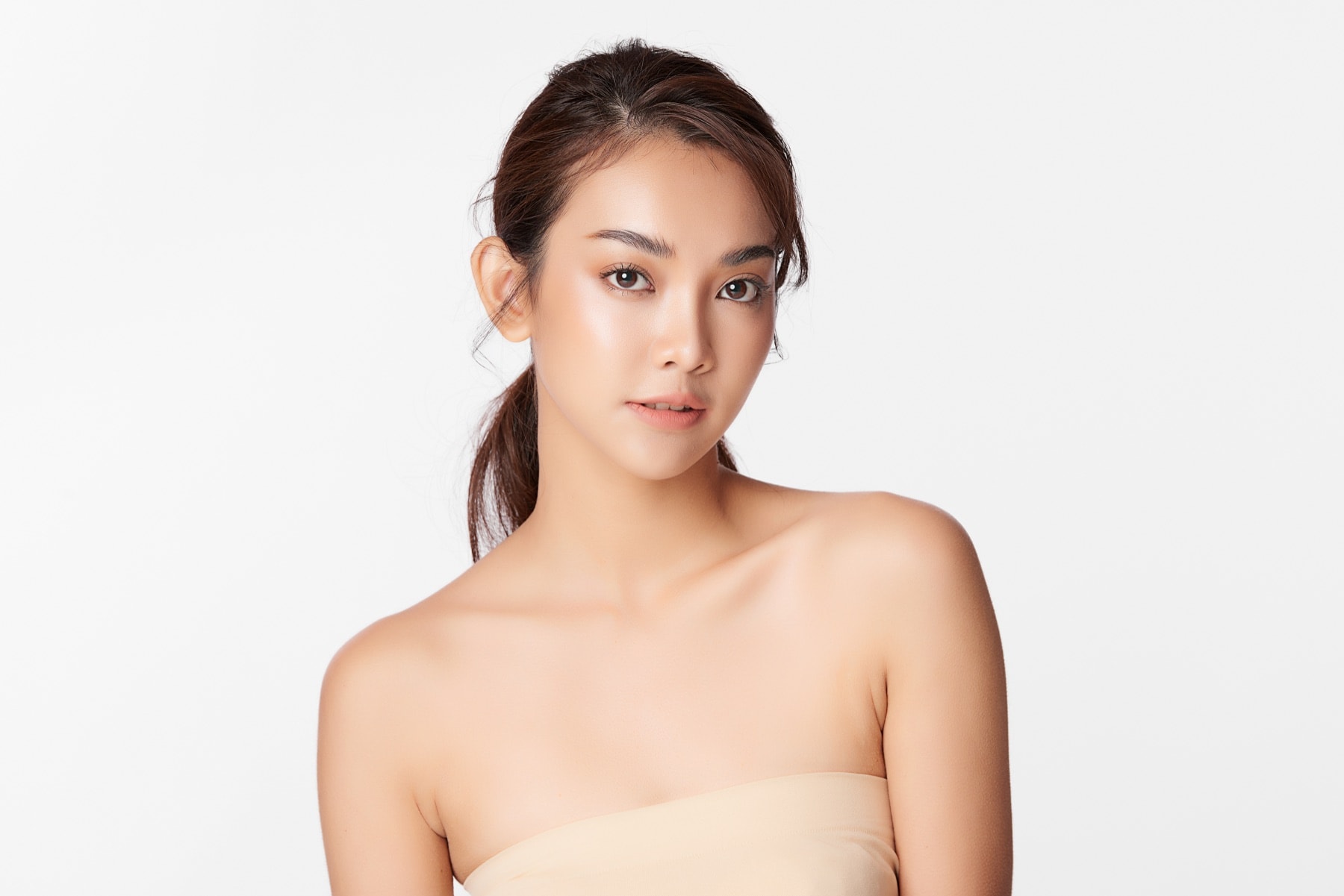 Studio portrait of a woman with clear, even-toned skin against a plain white background